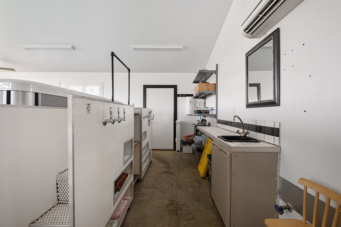 142 Zimmerhanzel Road Flatonia, TX 78941 - Photo 27 of 40 a kitchen with a sink stove and refrigerator
