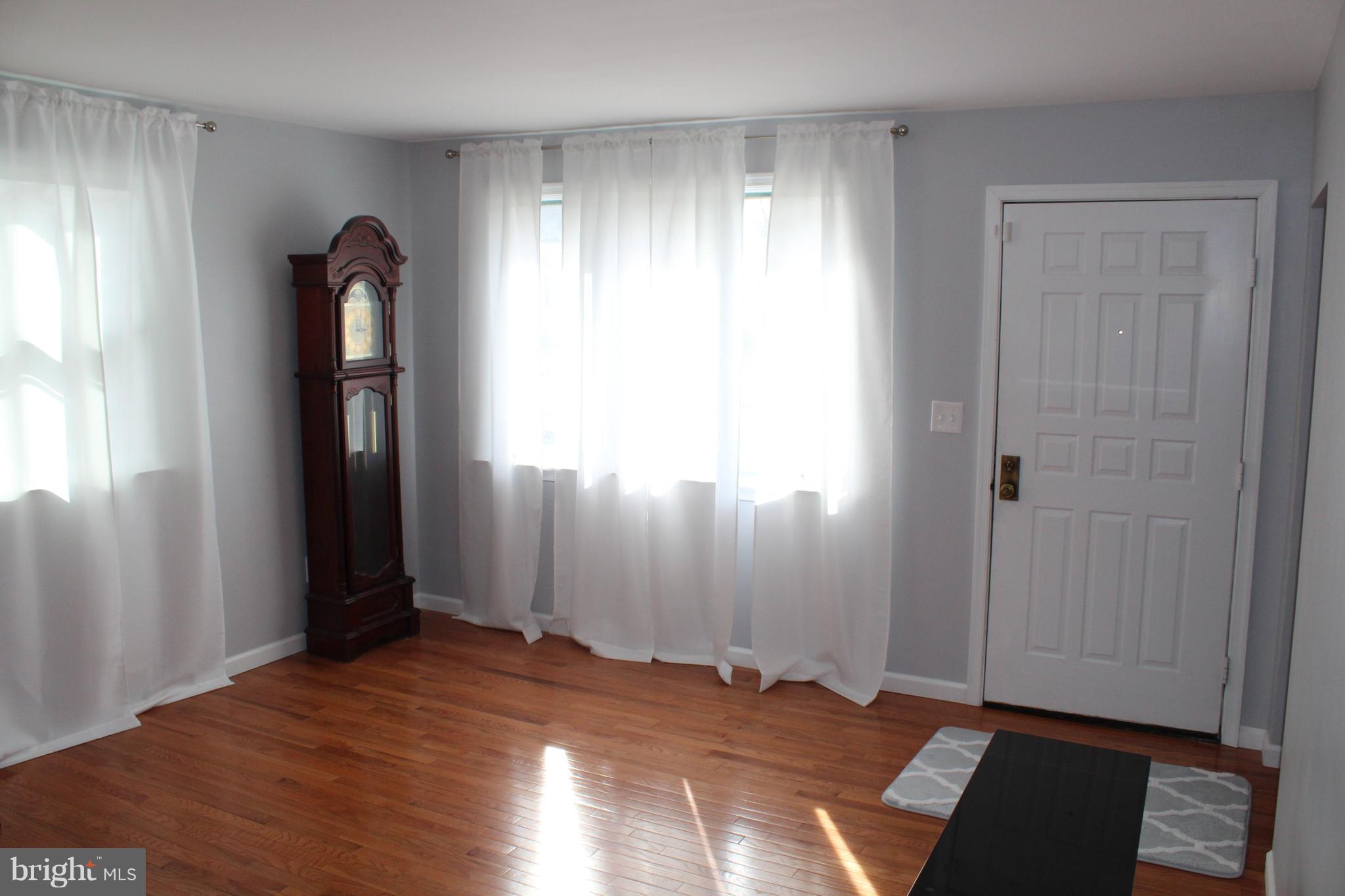82 Baylor Road Hamilton, NJ 08610 - Photo 4 of 17 a view of empty room with wooden floor and window