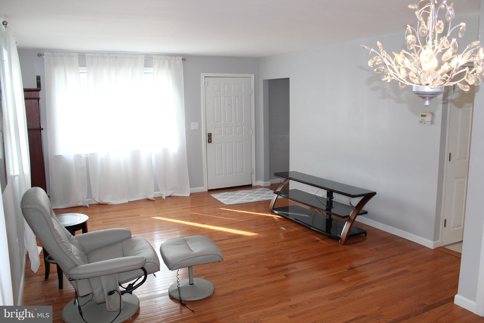 82 Baylor Road Hamilton, NJ 08610 - Photo 6 of 17 a room with furniture and a chandelier