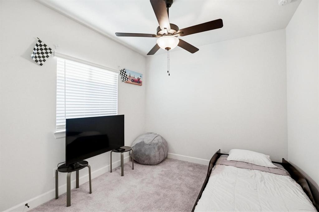 9341 Loggerhead Way Fort Worth, TX 76118 - Photo 26 of 35 Room featuring light-toned walls, a ceiling fan with integrated lighting, a window with horizontal blinds, and carpeting