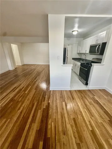 a view of kitchen with sink and wooden floor