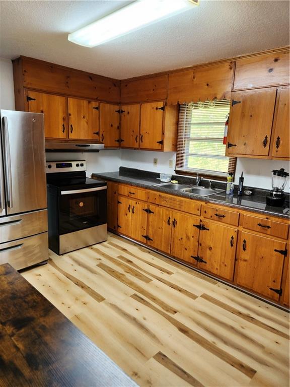 389 Collins Road Toccoa, GA 30577 - Photo 2 of 15 a kitchen with stainless steel appliances granite countertop a stove a sink and a refrigerator