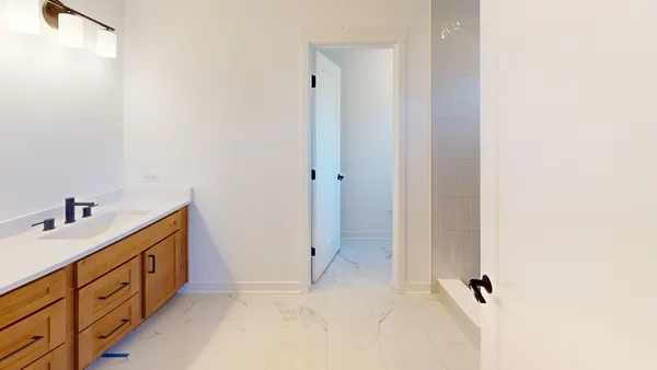 a bathroom with a double vanity sink and mirror