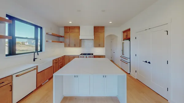 a kitchen with stainless steel appliances a refrigerator and a sink