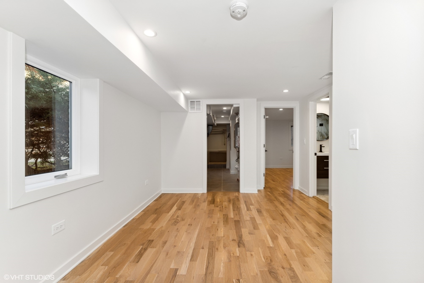 1025 Dewey Avenue Evanston, IL 60202 - Photo 13 of 21 a view of a big room with wooden floor and windows