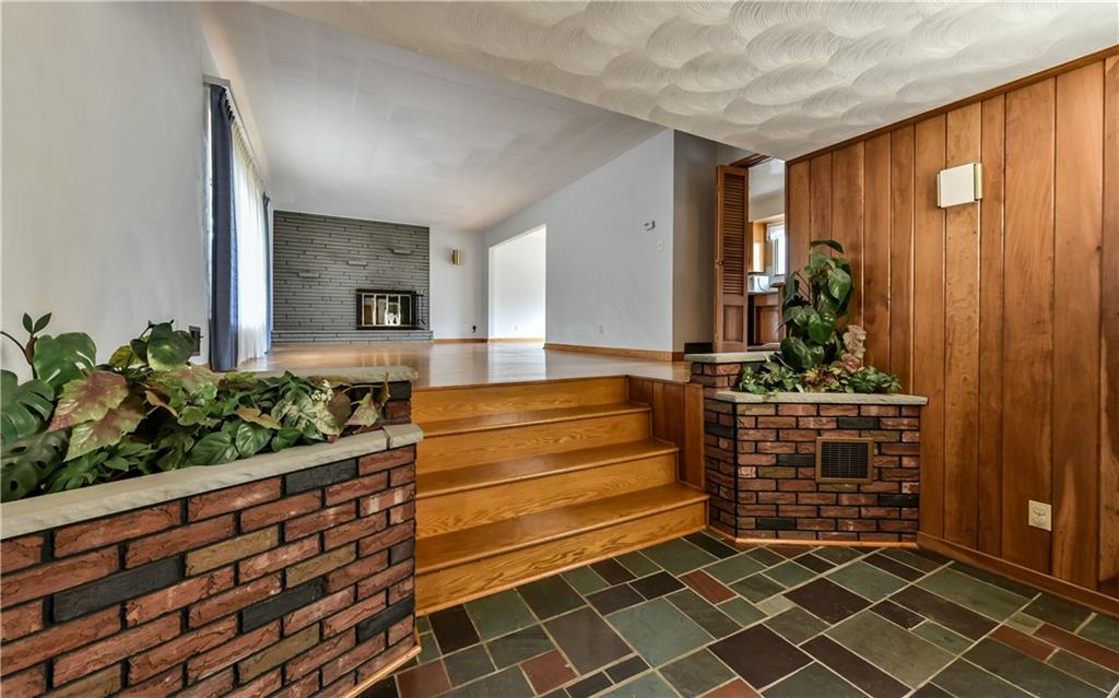 3891 Anderson Road Gibsonia, PA 15044 - Photo 2 of 22 Large foyer with brick planters, closet and cherry accent wall.