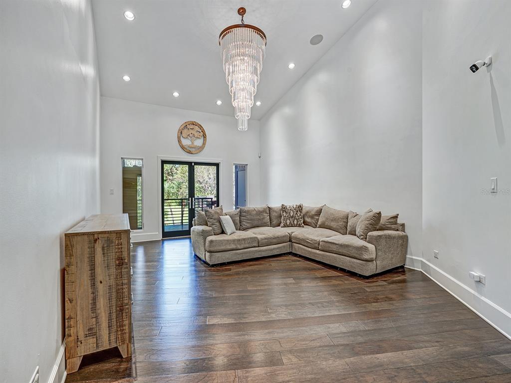 1609 Hampton Court Safety Harbor, FL 34695 - Photo 15 of 78 a living room with furniture chandelier and a large window