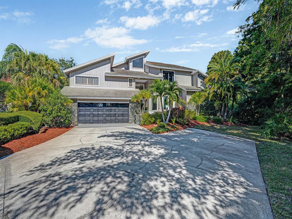 1609 Hampton Court Safety Harbor, FL 34695 - Photo 2 of 78 a front view of a house with a yard and garage