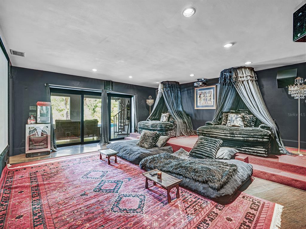 1609 Hampton Court Safety Harbor, FL 34695 - Photo 36 of 78 a living room with furniture a rug and a floor to ceiling window