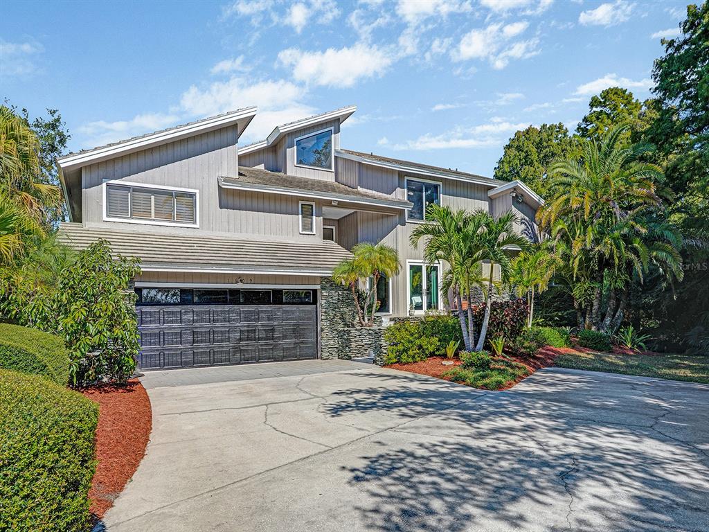 1609 Hampton Court Safety Harbor, FL 34695 - Photo 4 of 78 a front view of a house with garden