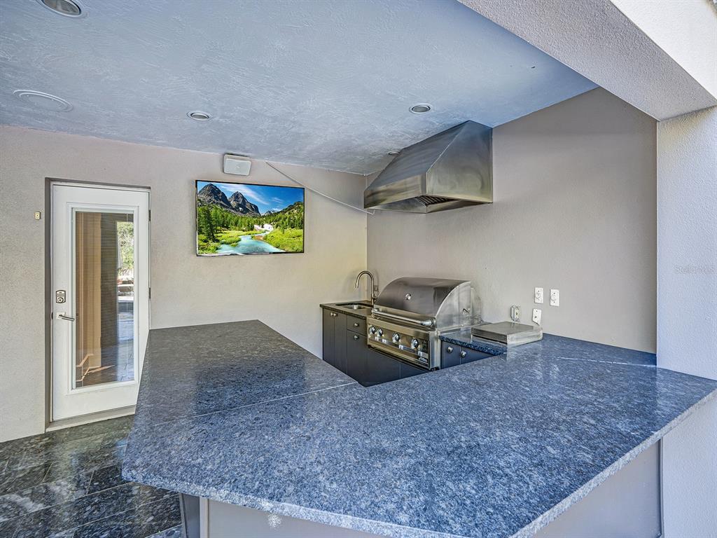 1609 Hampton Court Safety Harbor, FL 34695 - Photo 44 of 78 a kitchen with stainless steel appliances granite countertop a sink a stove and a wooden floor