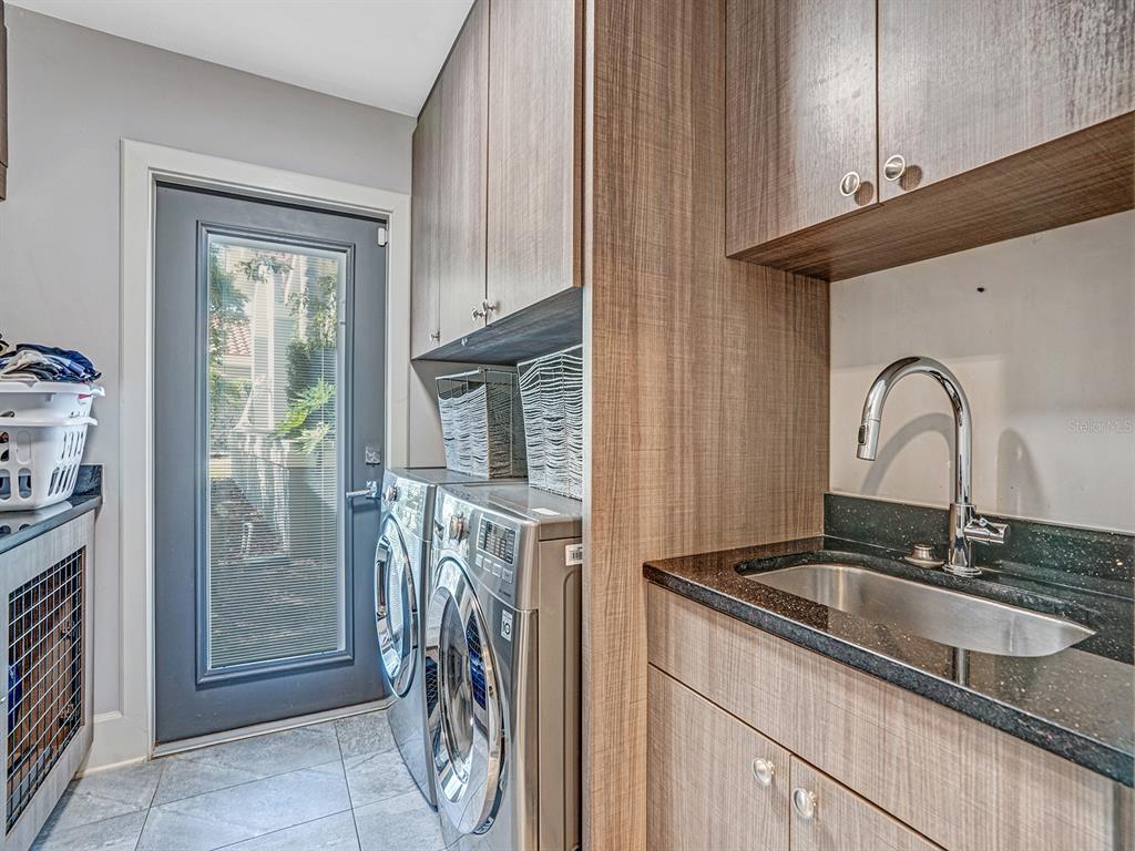 1609 Hampton Court Safety Harbor, FL 34695 - Photo 53 of 78 a kitchen with a sink and a refrigerator