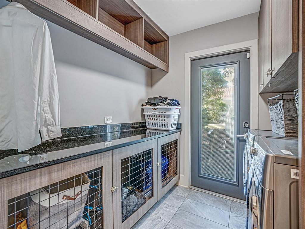1609 Hampton Court Safety Harbor, FL 34695 - Photo 54 of 78 a kitchen with stainless steel appliances granite countertop a stove and a sink