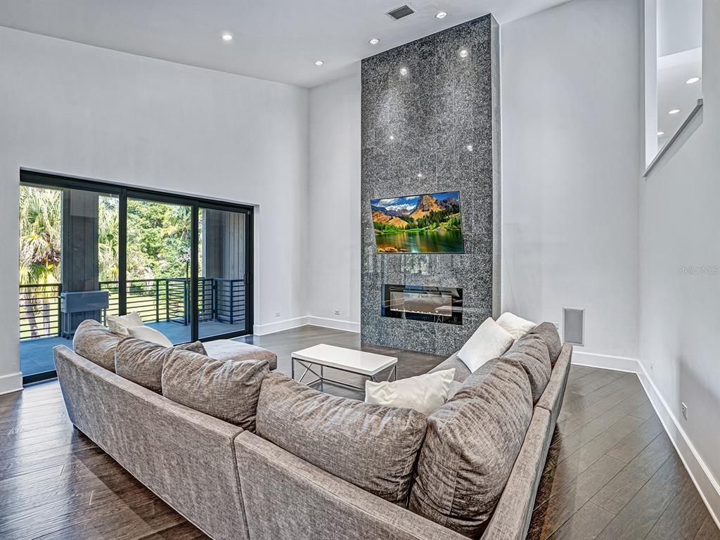 1609 Hampton Court Safety Harbor, FL 34695 - Photo 65 of 78 a living room with furniture and a floor to ceiling window