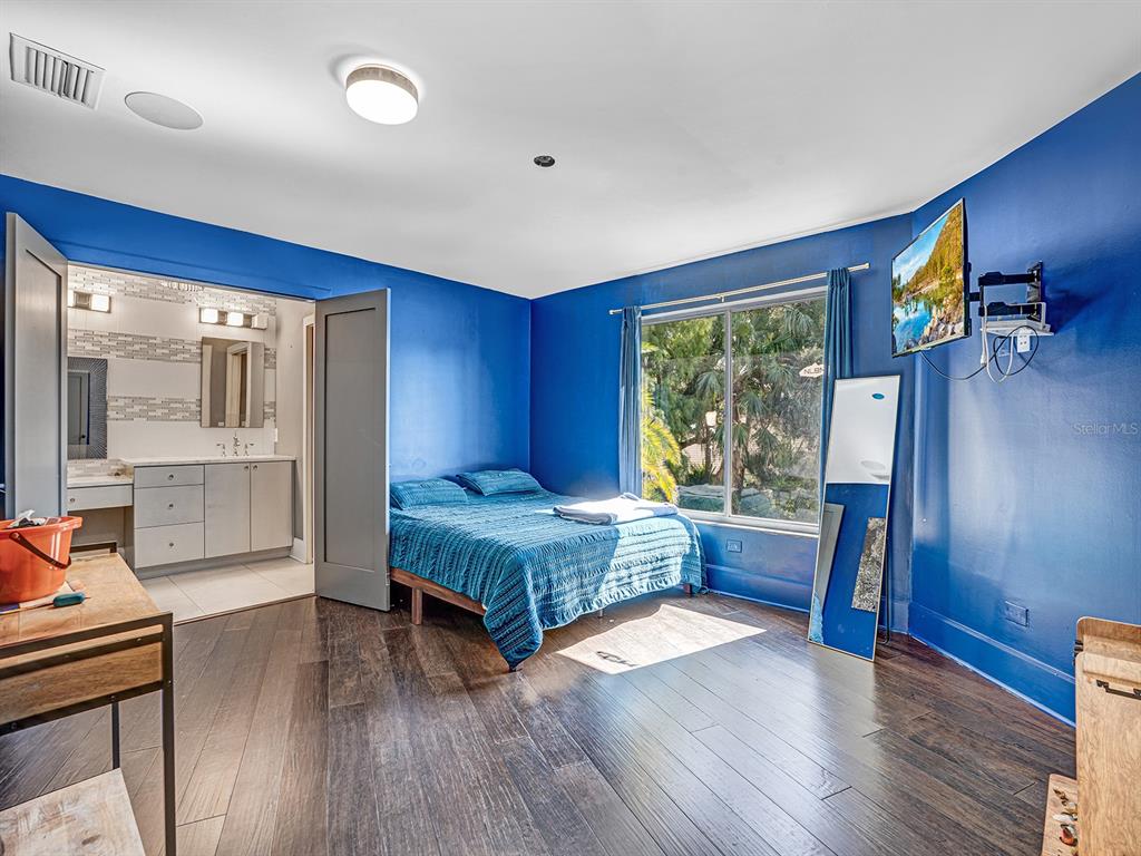 1609 Hampton Court Safety Harbor, FL 34695 - Photo 72 of 78 a bedroom with a bed and wooden floor