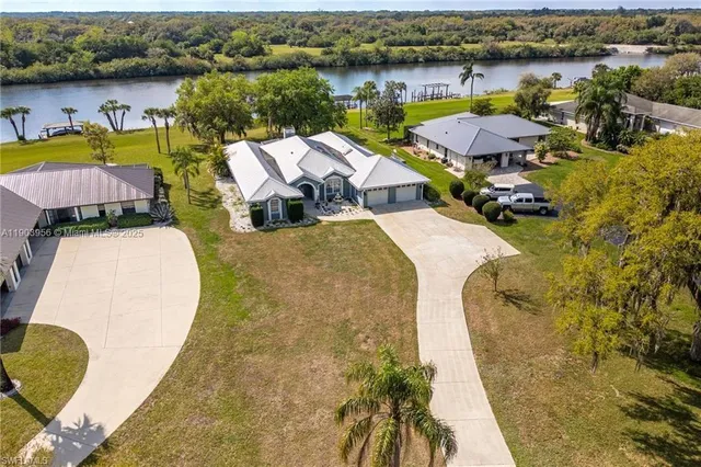an aerial view of a house with swimming pool and ocean view