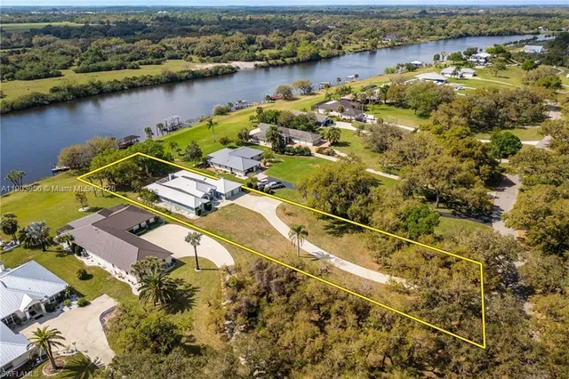 an aerial view of residential houses with outdoor space and river