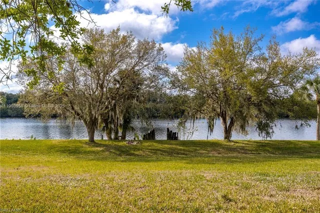 a view of a lake with houses in the back
