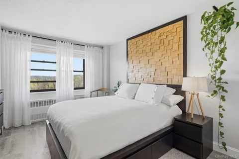 a bedroom with a bed and a potted plant