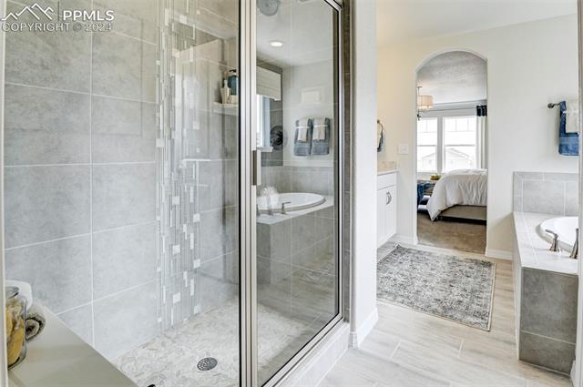 8539 Besson Court Colorado Springs, CO 80925 - Photo 21 of 28 Bathroom with separate shower and tub