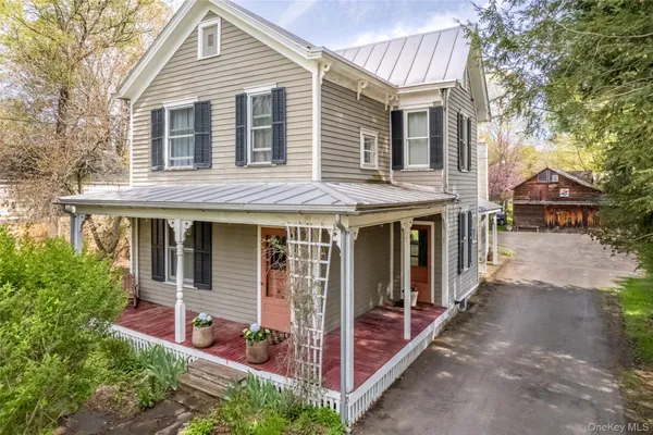 a view of a house with a yard and balcony