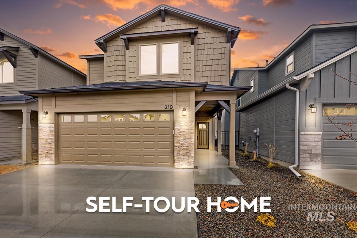 219 West Broyhill Street Meridian, ID 83642 - Photo 1 of 1 View of front of home with stone siding, driveway, and an attached garage
