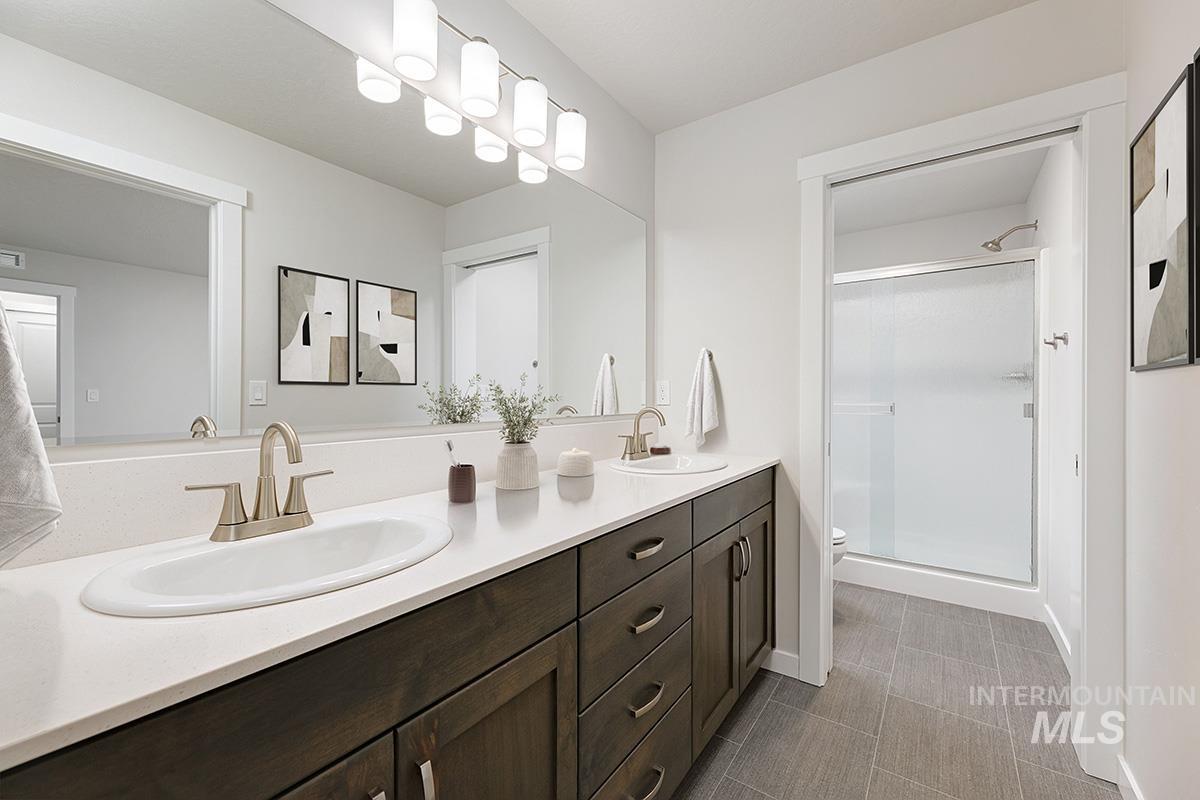 219 West Broyhill Street Meridian, ID 83642 - Photo 13 of 25 Bathroom with a shower stall and double vanity
