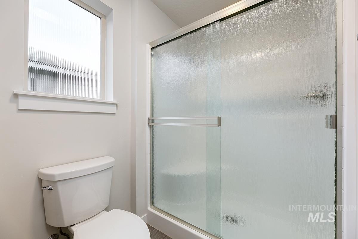 219 West Broyhill Street Meridian, ID 83642 - Photo 14 of 25 Full bathroom featuring a stall shower and toilet