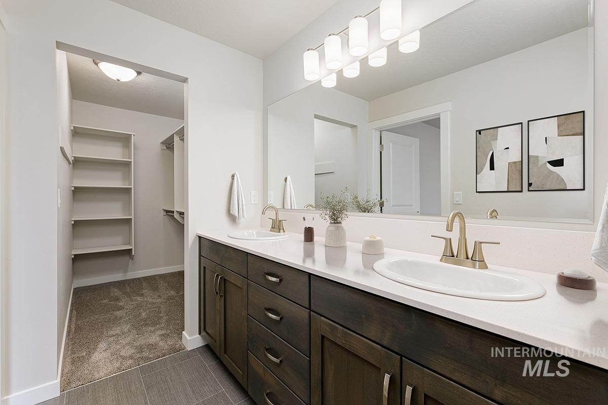 219 West Broyhill Street Meridian, ID 83642 - Photo 15 of 25 Full bathroom featuring double vanity, dark colored carpet, and a spacious closet