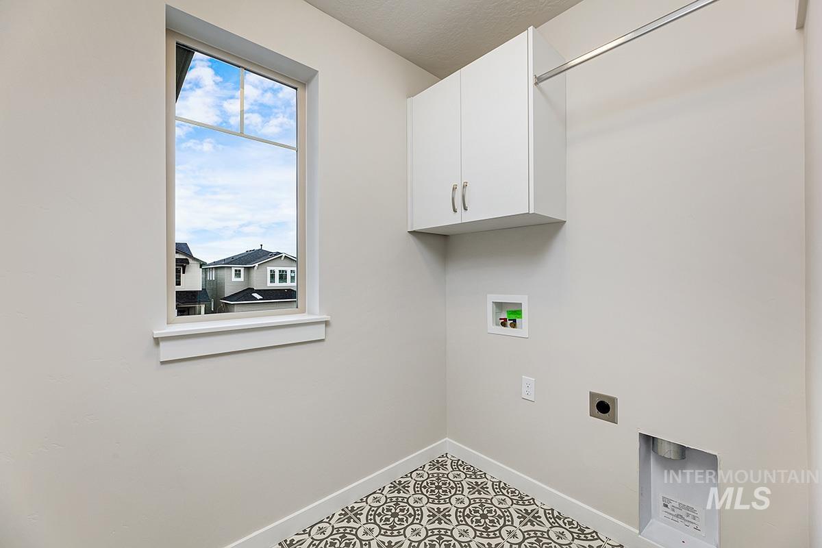 219 West Broyhill Street Meridian, ID 83642 - Photo 18 of 25 Laundry room featuring hookup for an electric dryer, washer hookup, cabinet space, and a textured ceiling
