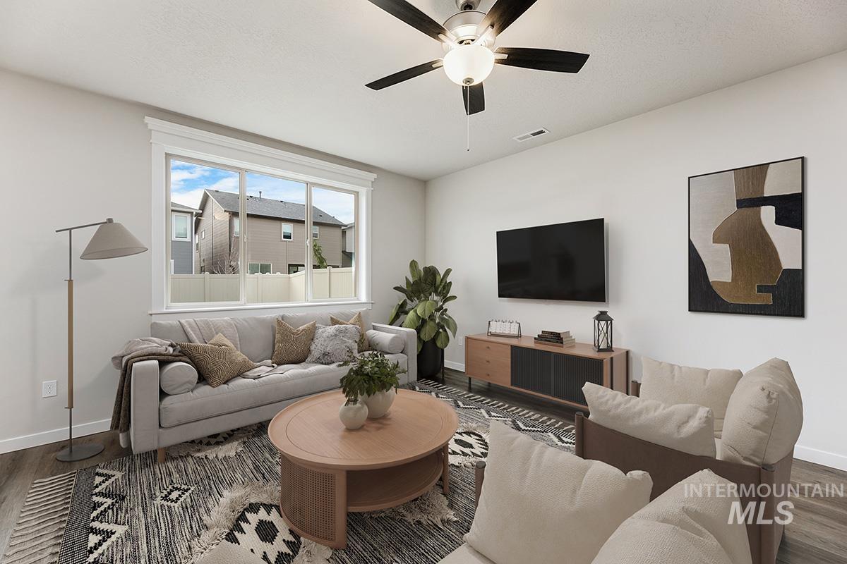 219 West Broyhill Street Meridian, ID 83642 - Photo 4 of 25 Living area featuring wood finished floors and a ceiling fan