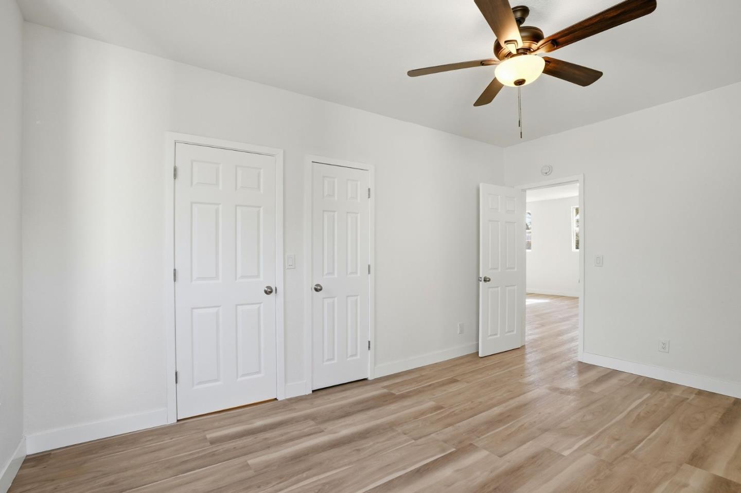 345 South Pilgrim Street Stockton, CA 95205 - Photo 14 of 27 an empty room with wooden floor fan and windows