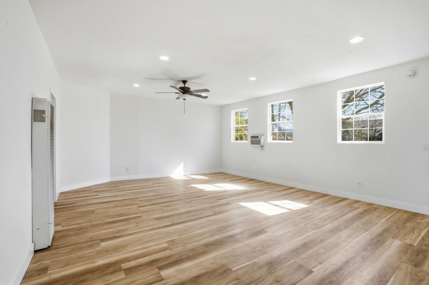 345 South Pilgrim Street Stockton, CA 95205 - Photo 7 of 27 a view of an empty room with window and wooden floor