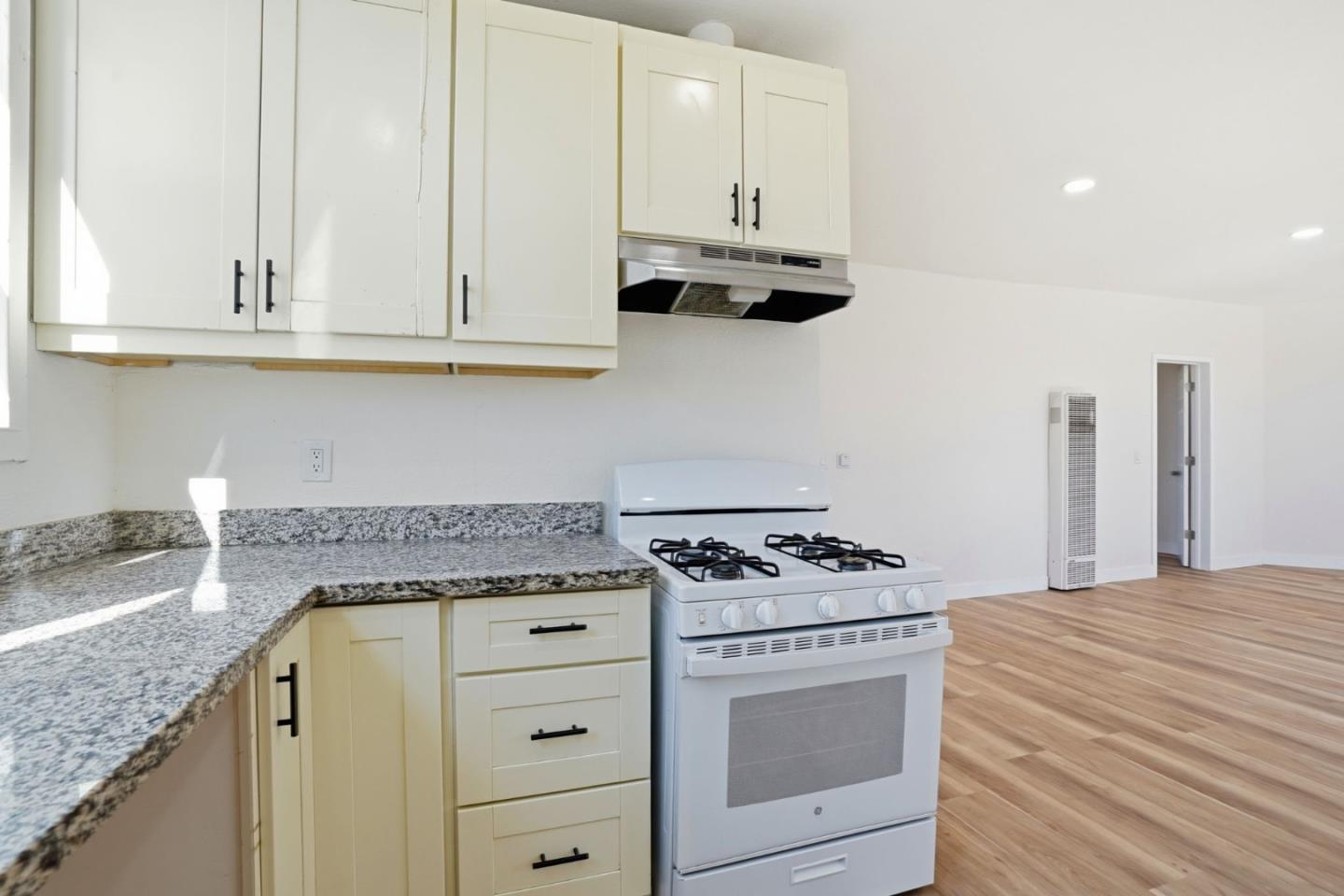 345 South Pilgrim Street Stockton, CA 95205 - Photo 9 of 27 a kitchen with granite countertop white cabinets and white appliances