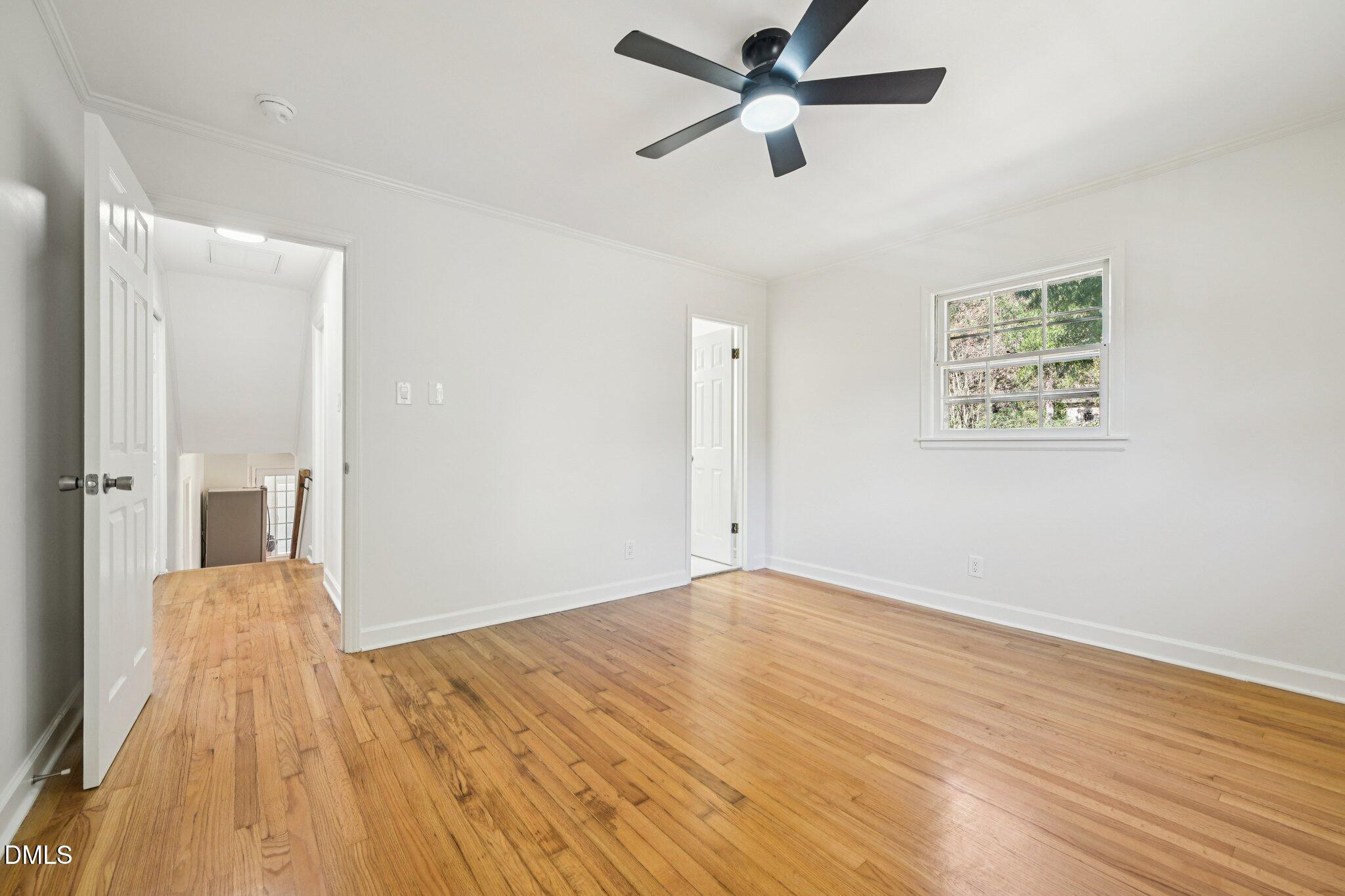 515 Uzzle Street Durham, NC 27713 - Photo 11 of 26 an empty room with wooden floor and a ceiling fan