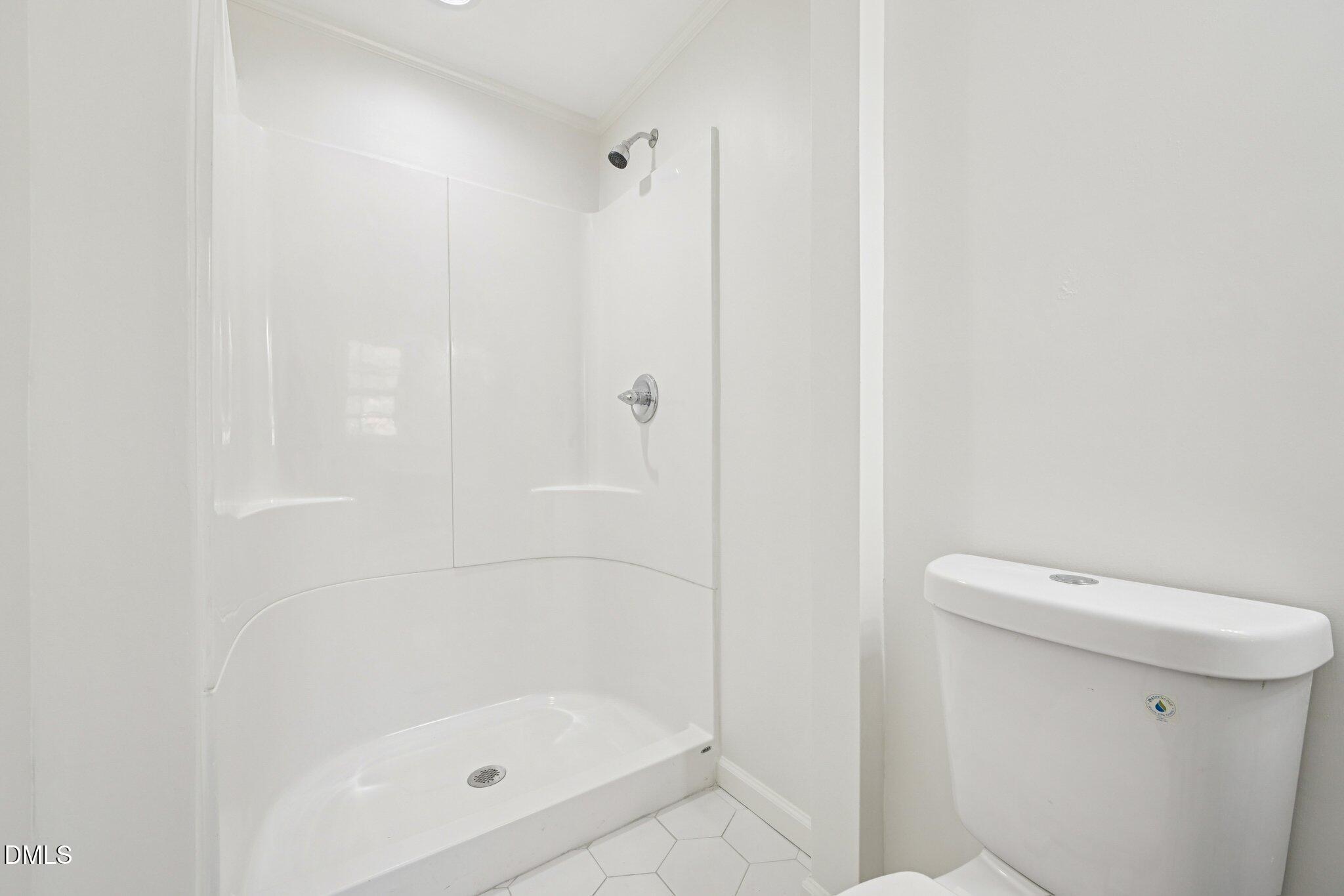 515 Uzzle Street Durham, NC 27713 - Photo 12 of 26 a bathroom with a shower a toilet and a sink