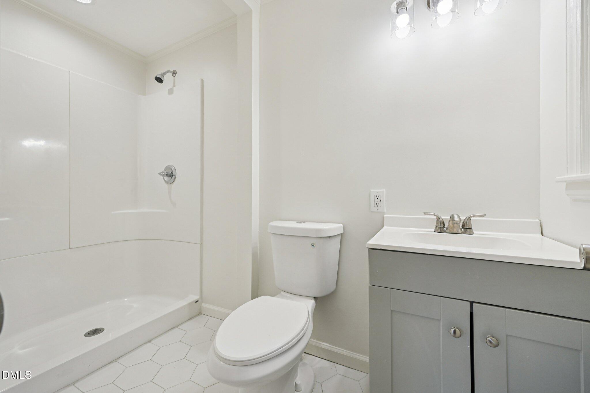 515 Uzzle Street Durham, NC 27713 - Photo 13 of 26 a white toilet sitting next to a bathroom sink