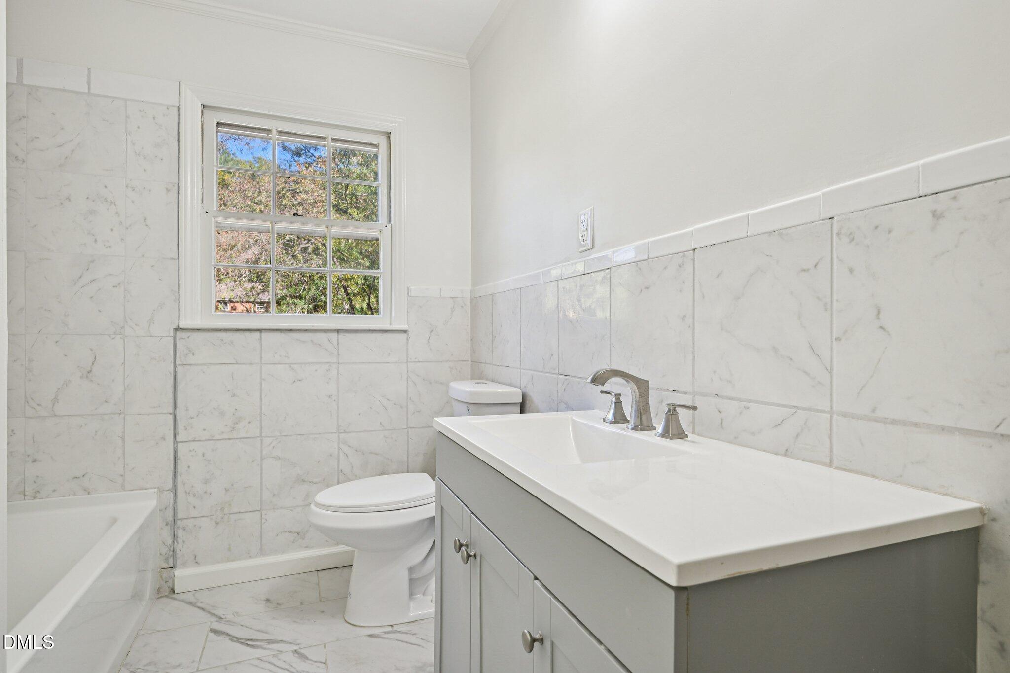 515 Uzzle Street Durham, NC 27713 - Photo 17 of 26 a bathroom with a sink a toilet and shower