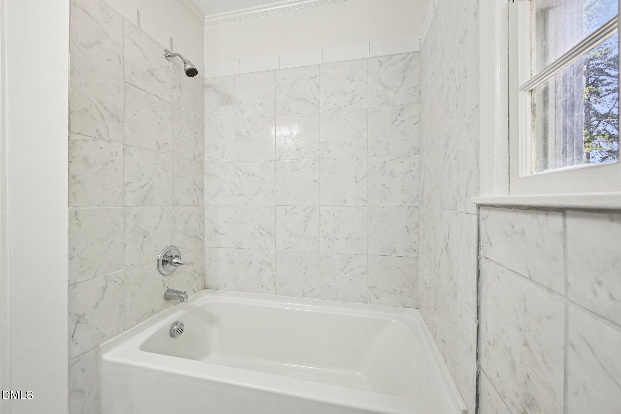 515 Uzzle Street Durham, NC 27713 - Photo 18 of 26 a white bath tub sitting next to a window