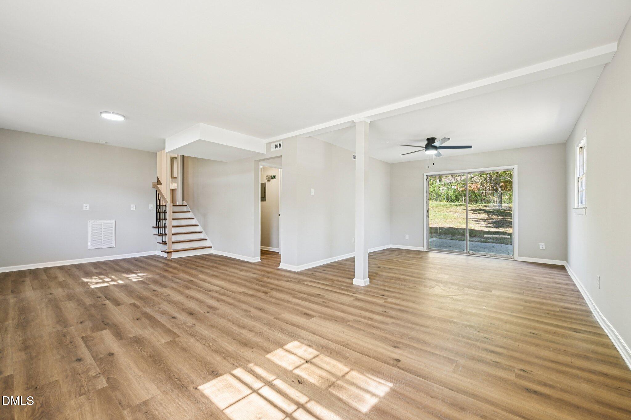 515 Uzzle Street Durham, NC 27713 - Photo 21 of 26 a view of an empty room with wooden floor and a window