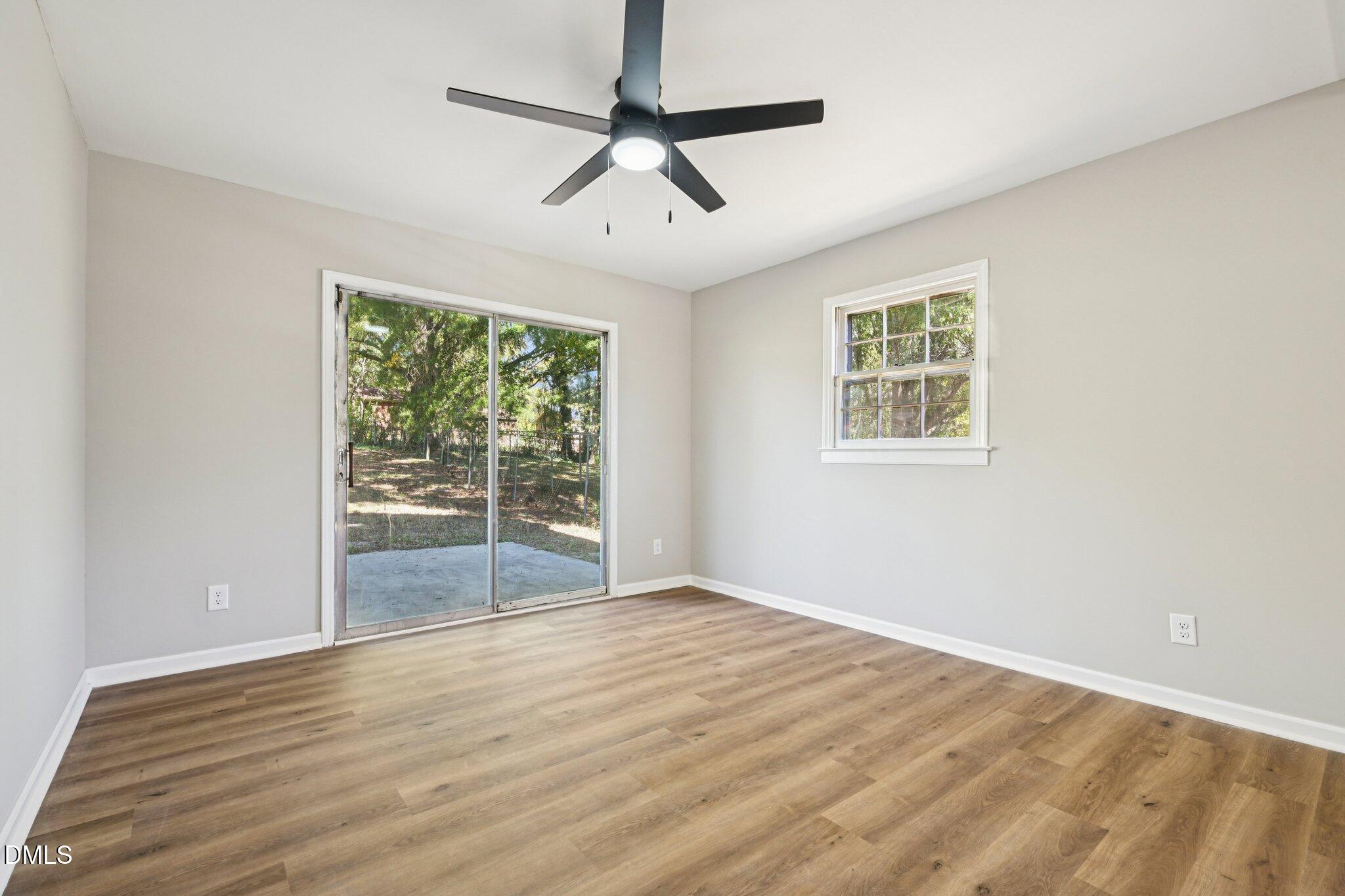 515 Uzzle Street Durham, NC 27713 - Photo 22 of 26 a view of an empty room with wooden floor and a window
