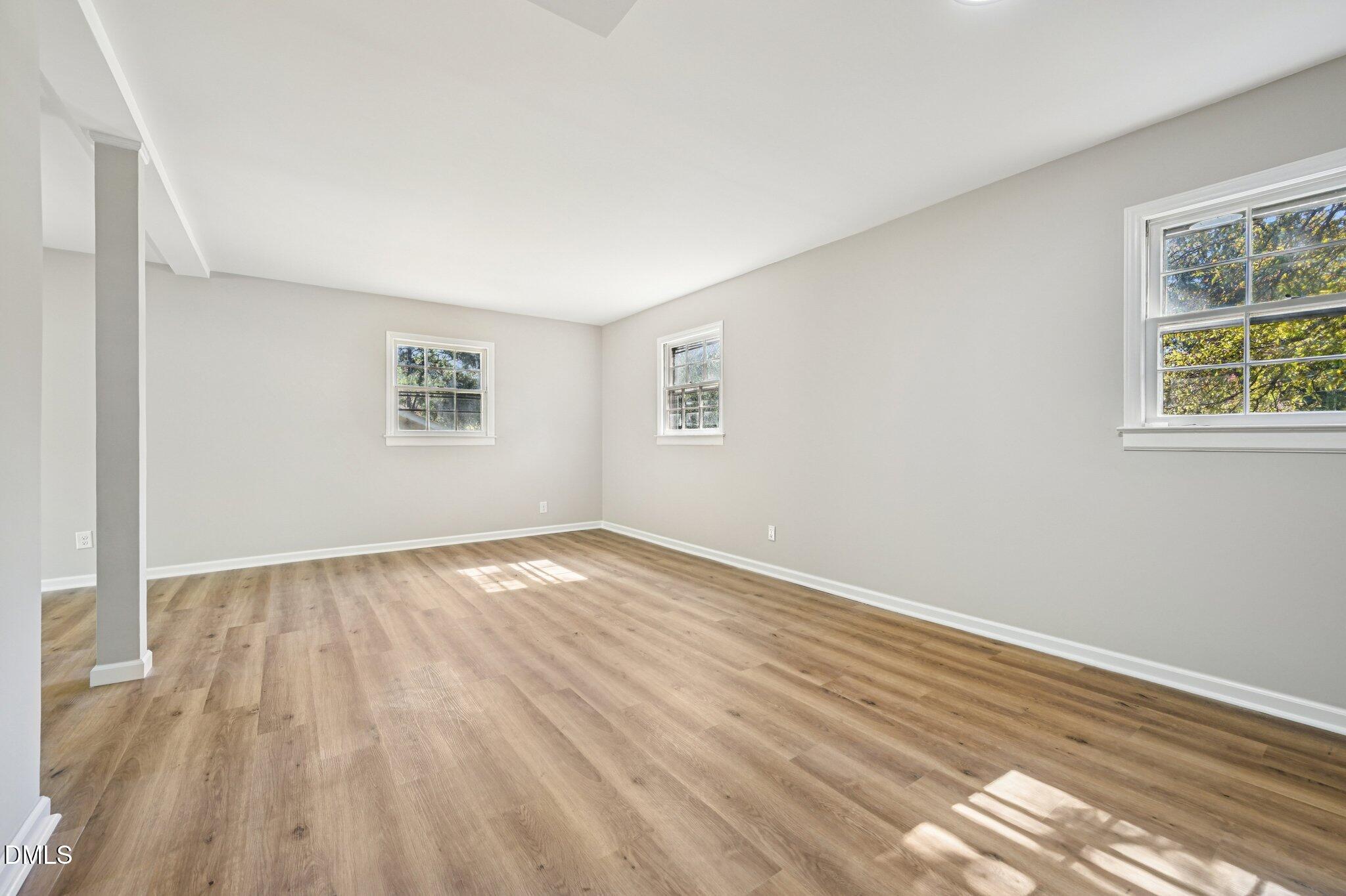 515 Uzzle Street Durham, NC 27713 - Photo 23 of 26 a view of empty room with wooden floor and fan