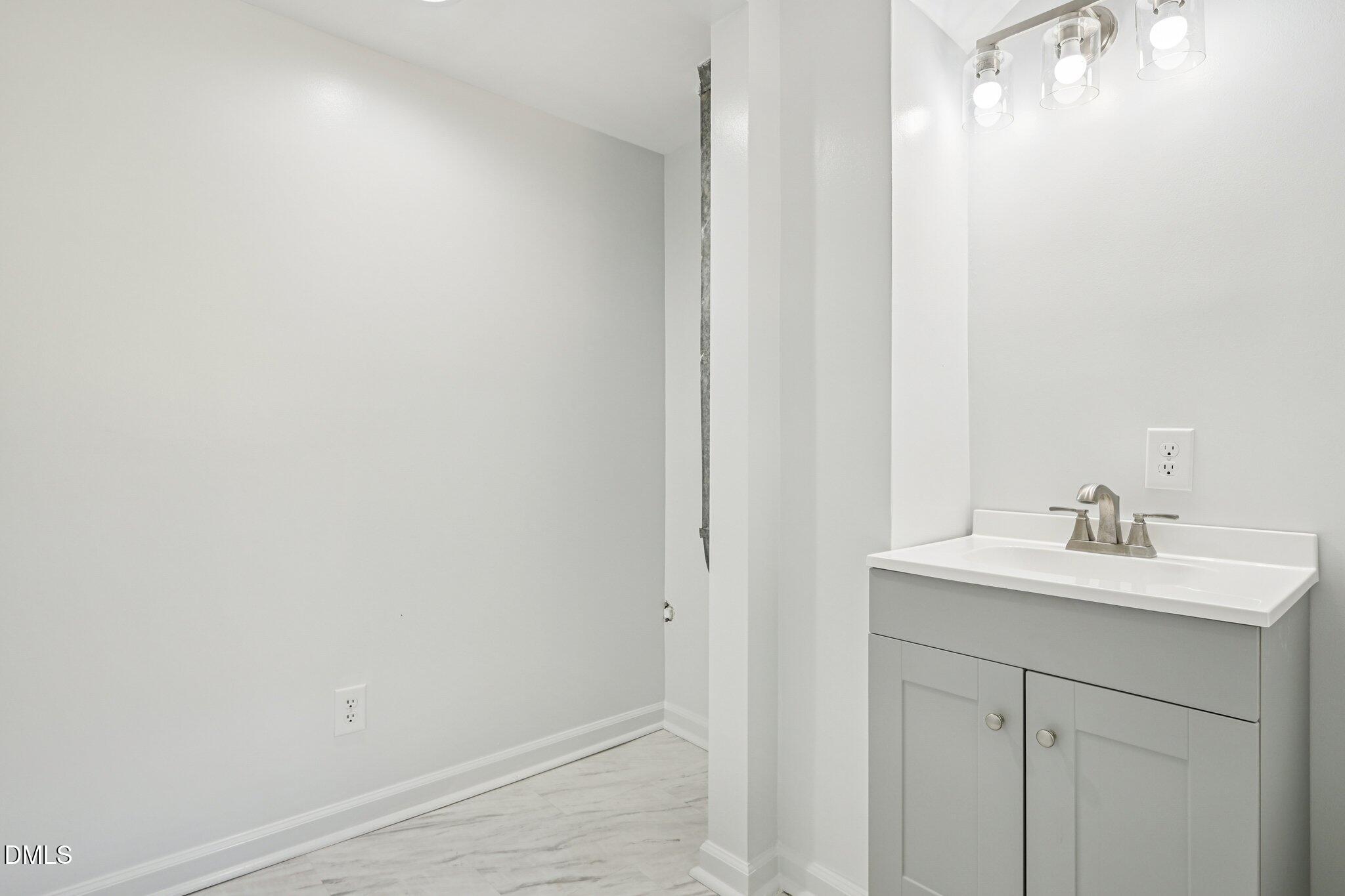 515 Uzzle Street Durham, NC 27713 - Photo 25 of 26 a bathroom with a sink and a mirror