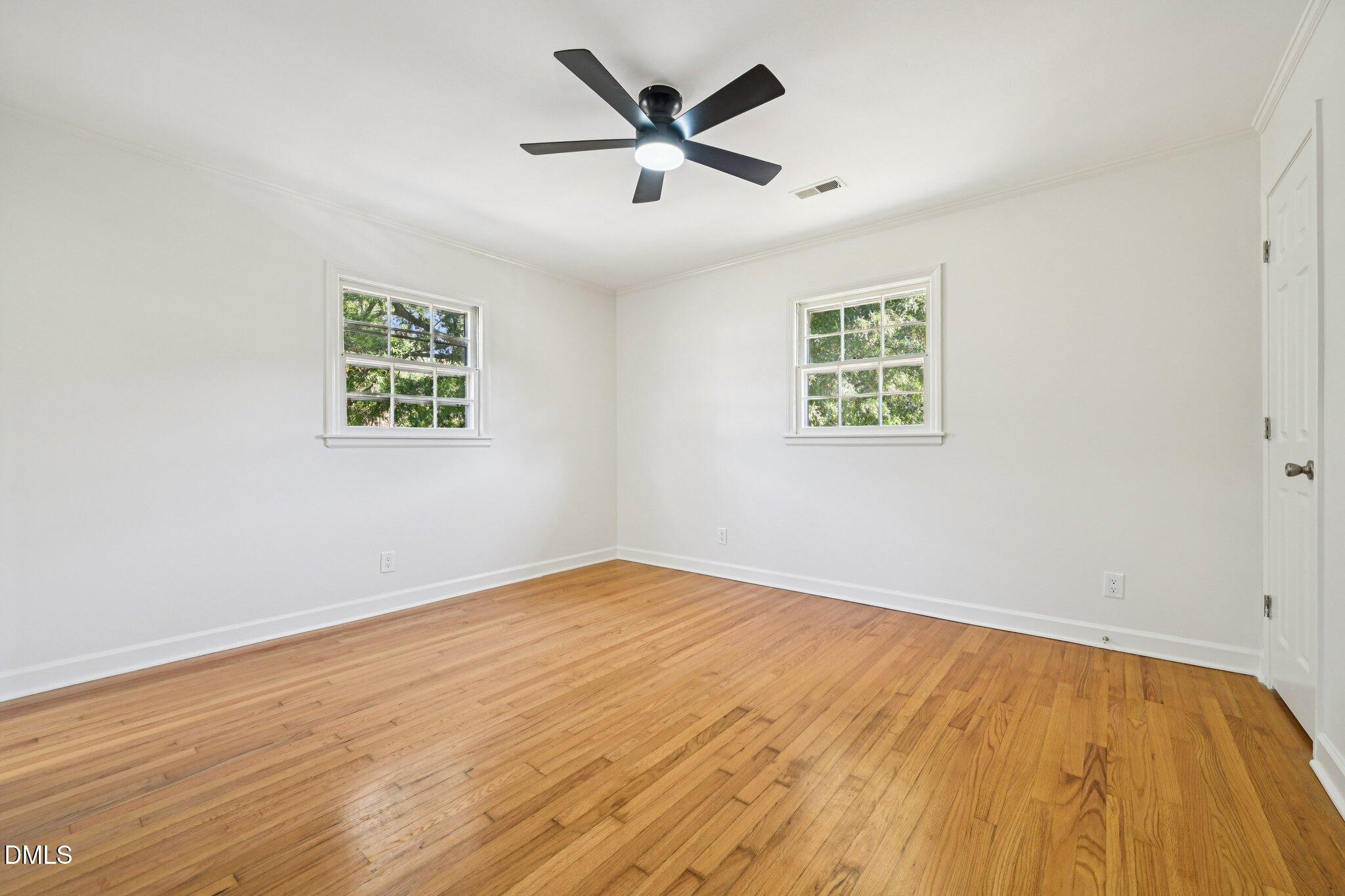 515 Uzzle Street Durham, NC 27713 - Photo 10 of 26 an empty room with wooden floor and ceiling fan