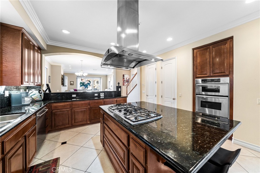 116 11th Street Huntington Beach, CA 92648 - Photo 13 of 28 a kitchen with stainless steel appliances kitchen island a wooden counter tops and a stove