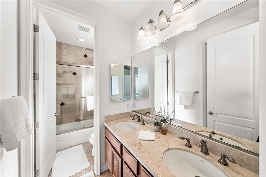 116 11th Street Huntington Beach, CA 92648 - Photo 19 of 28 a bathroom with a sink double vanity and a mirror