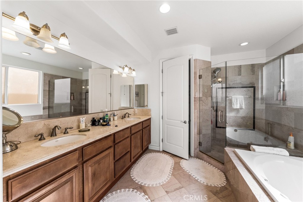 116 11th Street Huntington Beach, CA 92648 - Photo 22 of 28 a bathroom with a double vanity sink mirror double vanity and shower