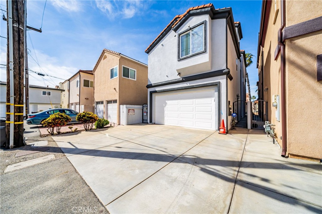 116 11th Street Huntington Beach, CA 92648 - Photo 24 of 28 a building exterior with a car parked