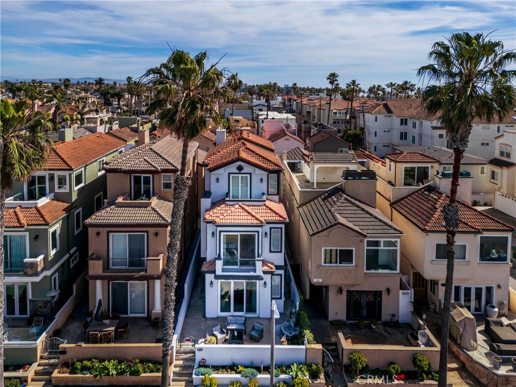 116 11th Street Huntington Beach, CA 92648 - Photo 4 of 28 a front view of a residential apartment building with a yard