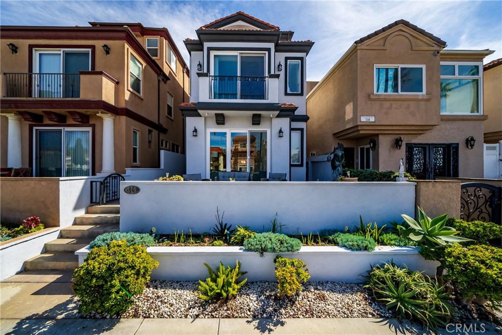 116 11th Street Huntington Beach, CA 92648 - Photo 7 of 28 a front view of a house with a yard and outdoor seating